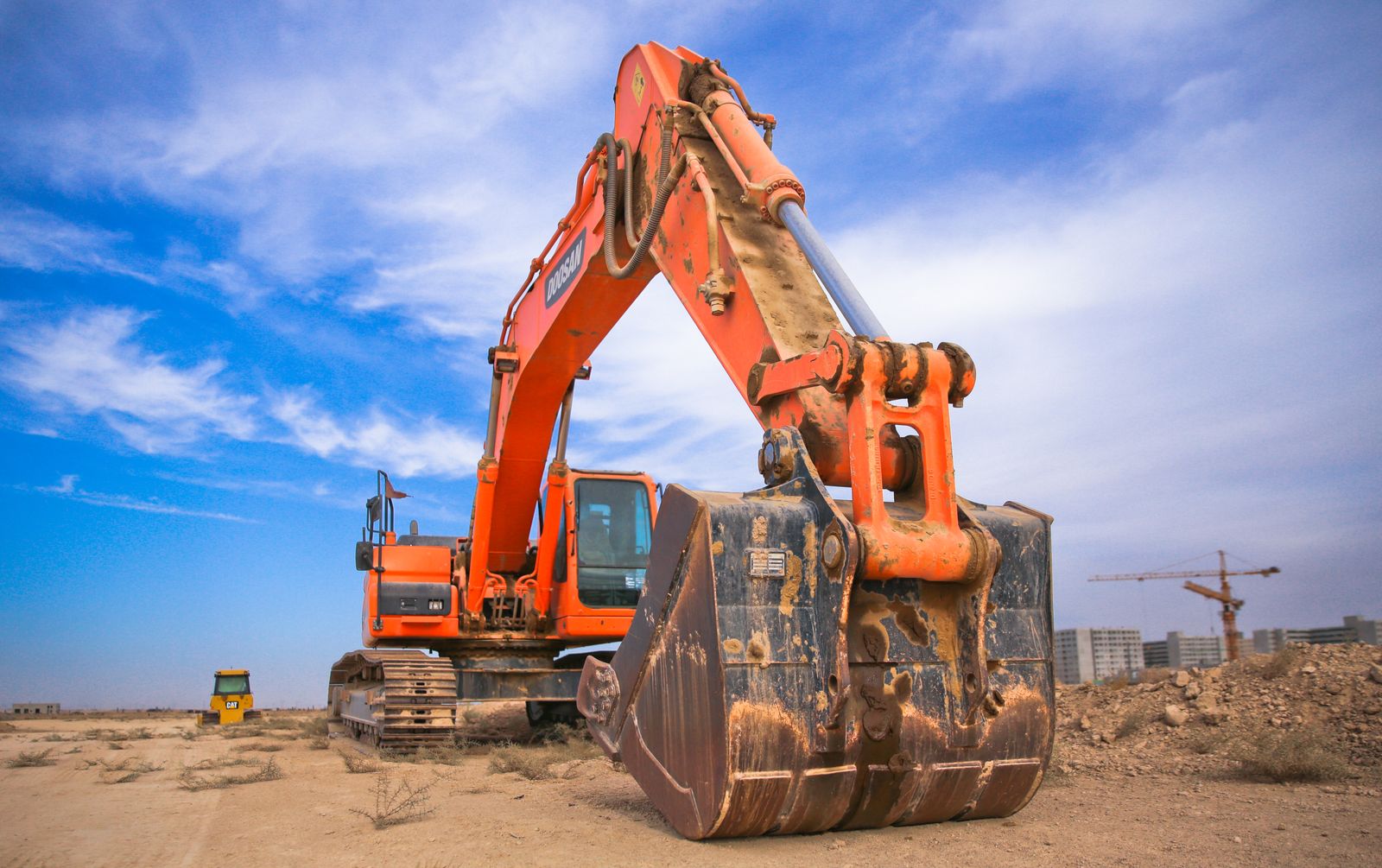 Excavator bucket and tracks on an active dig site